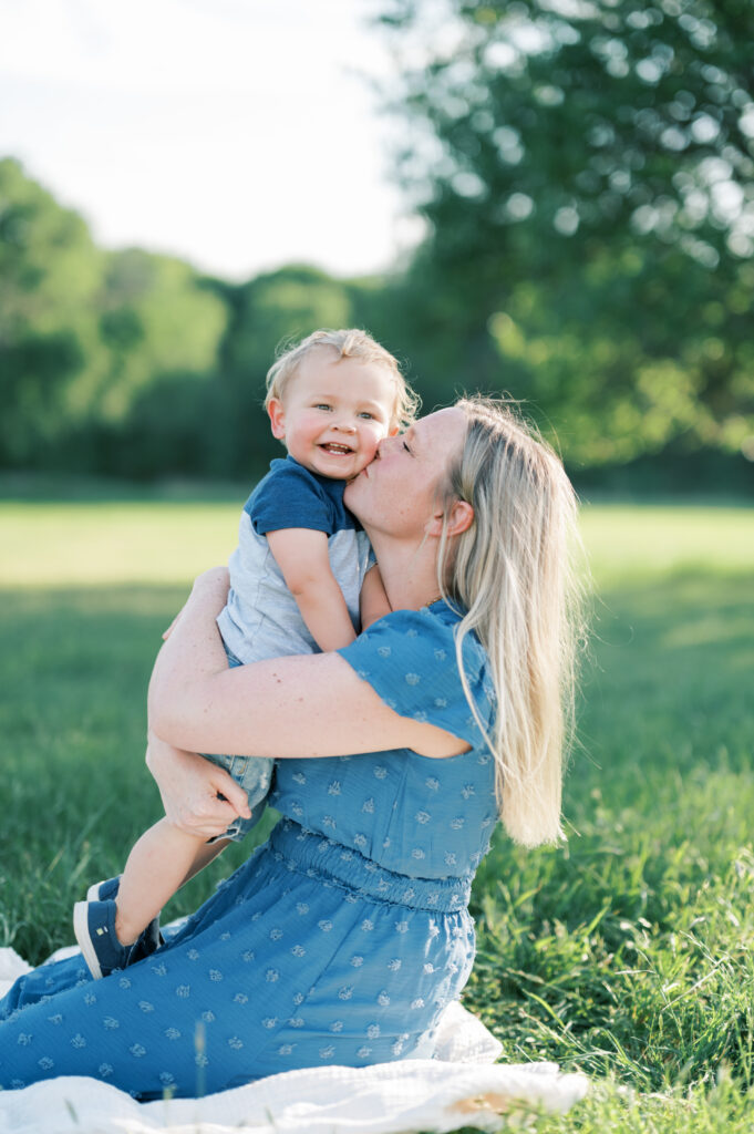 mom kisses young son during family photo session