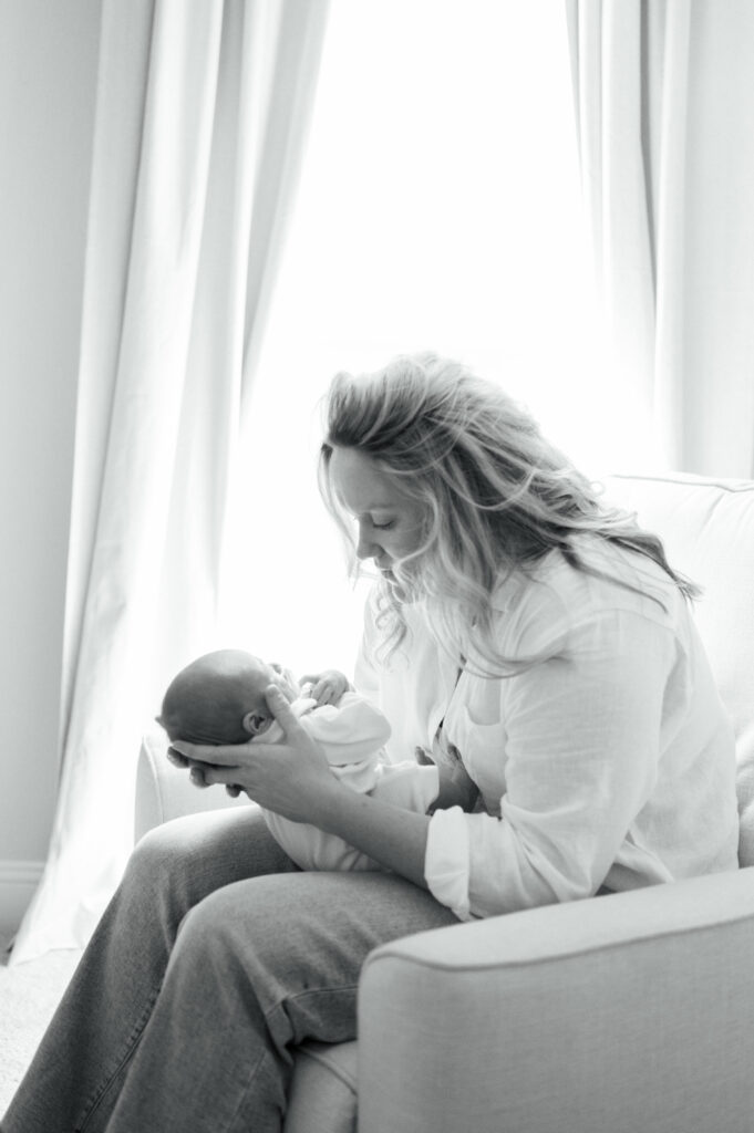 mom holds newborn baby during at home newborn session