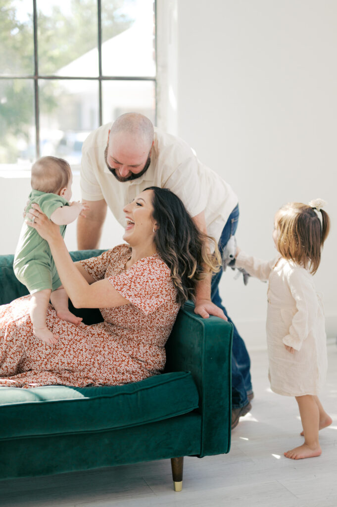studio family photos, family gathers around baby boy