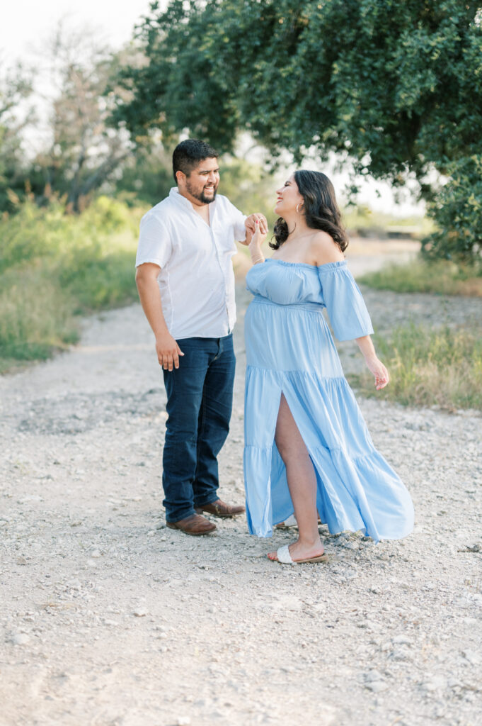 maternity photography session in fort worth - expecting parents dance on a gravel trail