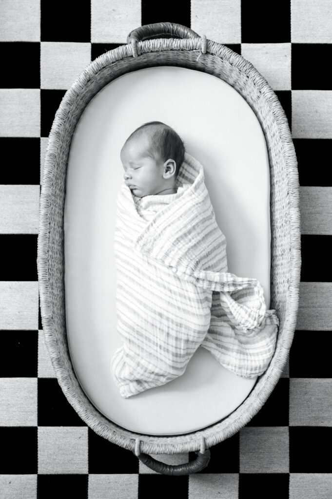baby sleeping in basket, lifestyle newborn photography at home