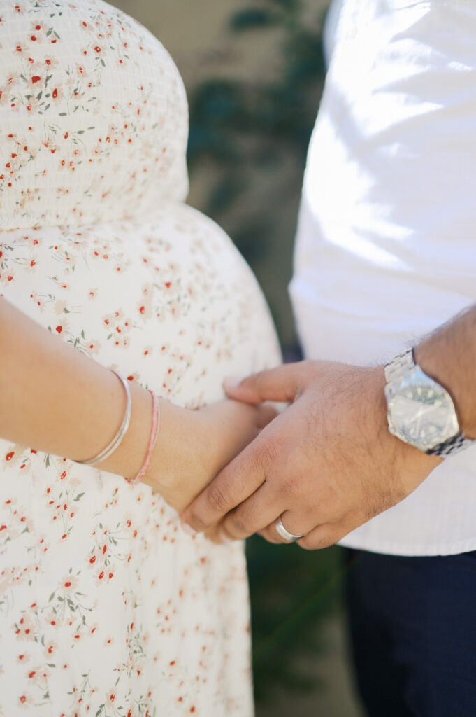 expecting parents embrace baby bump during maternity photos