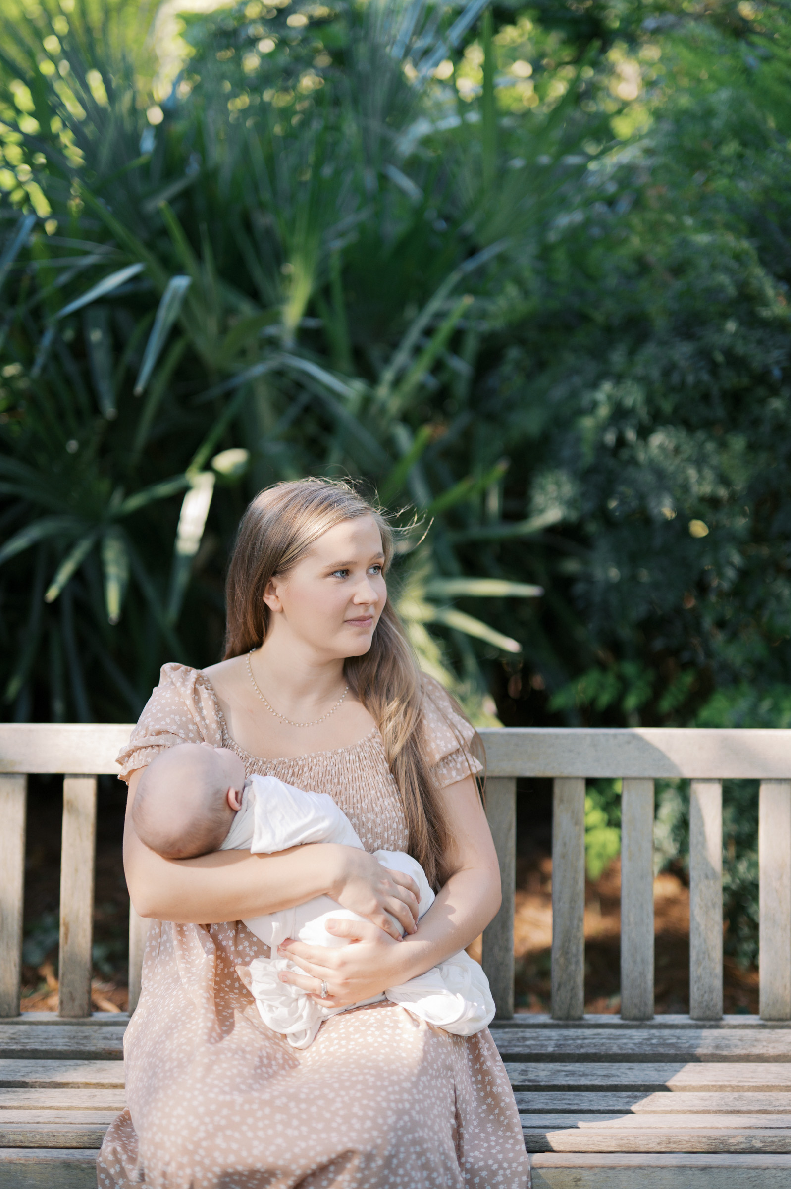 mom holds baby on bench