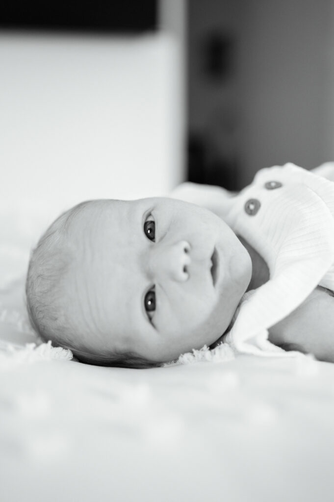 newborn baby lays wide awake