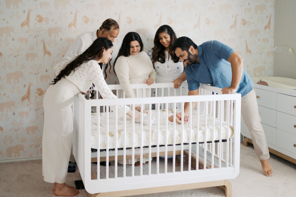 extended family gathers during newborn photo session
