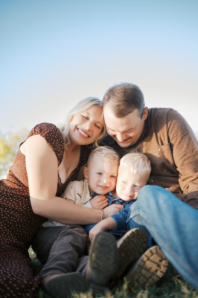family snuggles in close during family photography session in fort worth