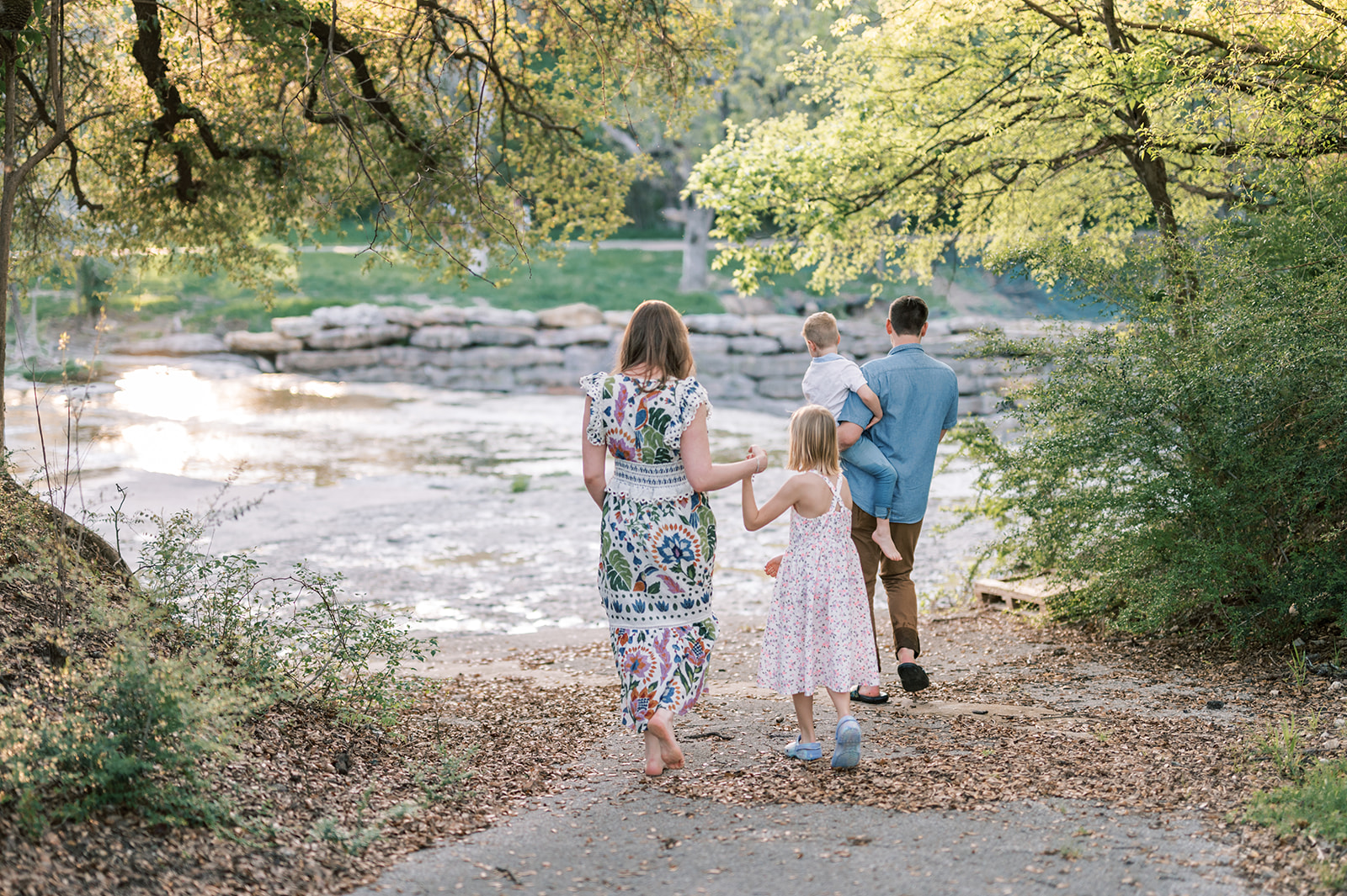 family-friendly things to do in fort worth, family walking through creek in airfield falls