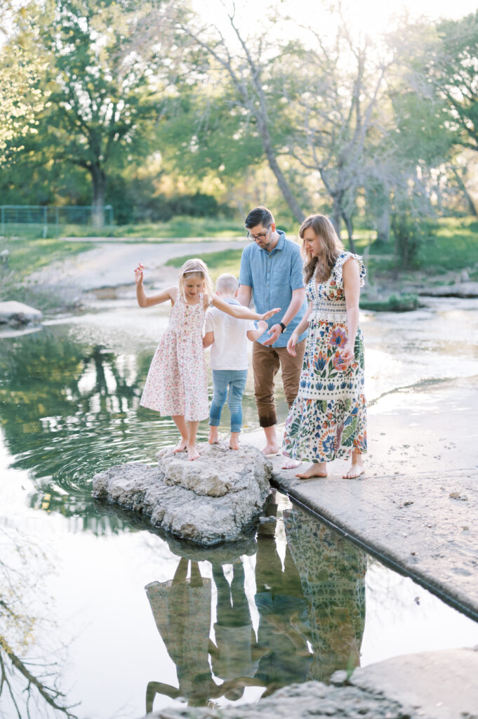 a family stands creekside in fort worth