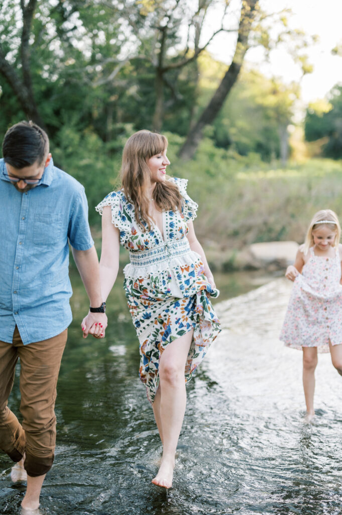 family walks through a creek in fort worth