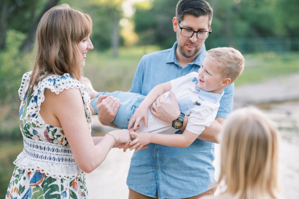 a family plays together in a creek in fort worth