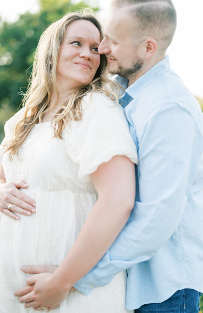 expecting parents pose for a maternity session