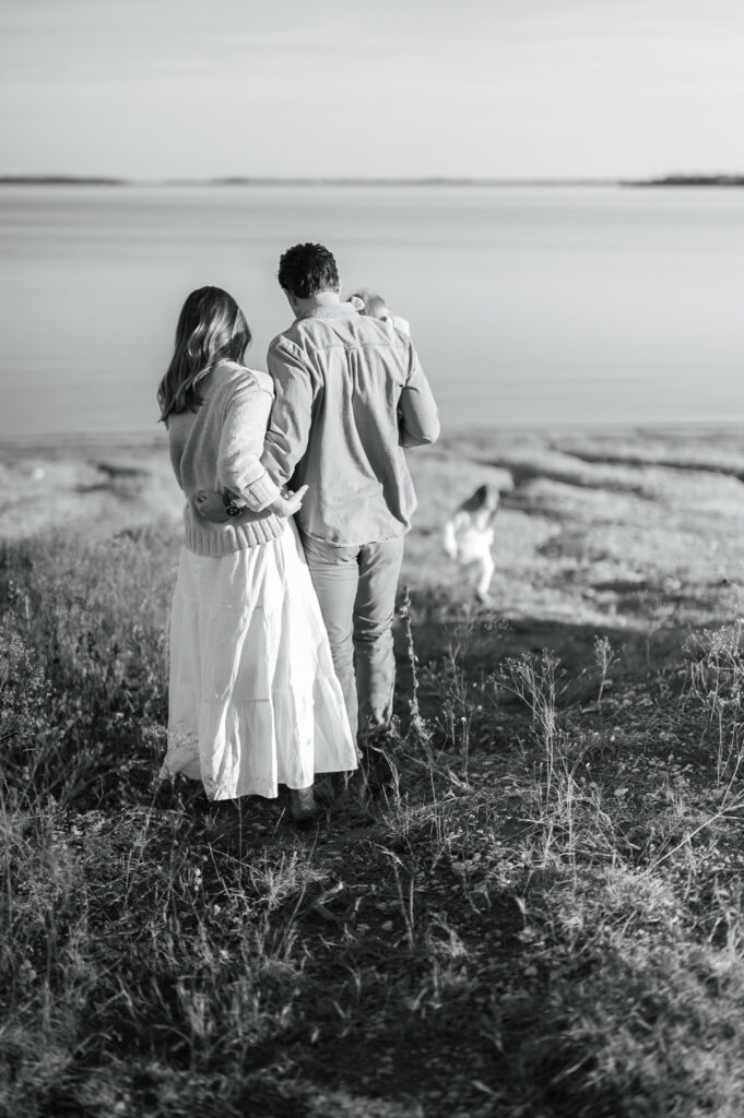 mom and dad hug each other as they walk with their family