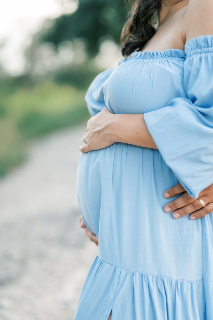 mom and dad hold baby bump