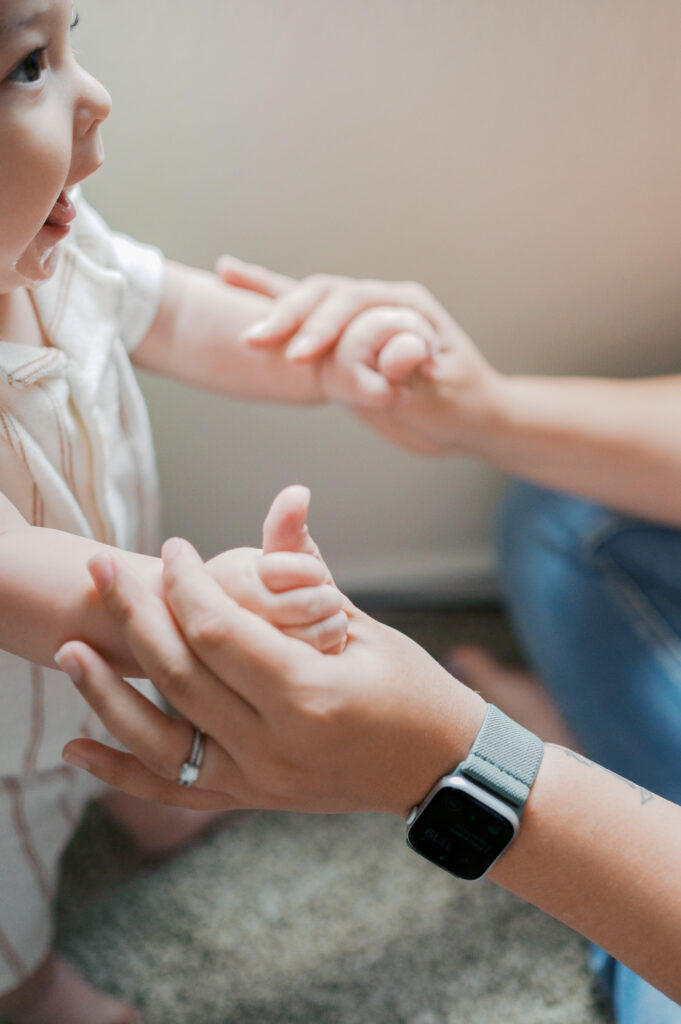 mom holds son's hands 