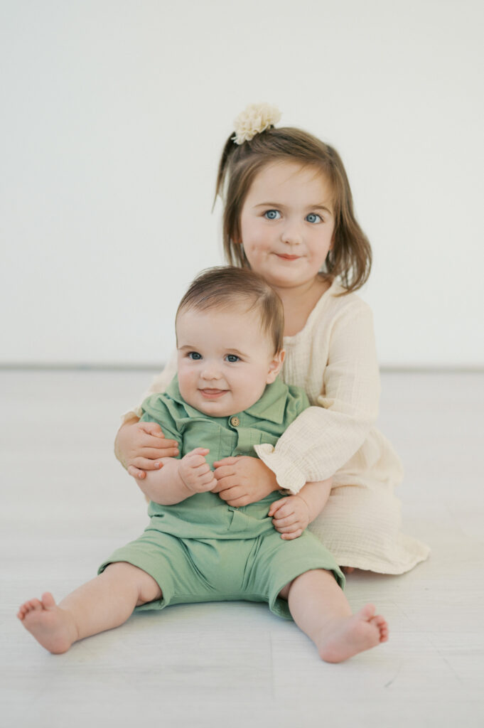 siblings hug during indoor family photos fort worth studio