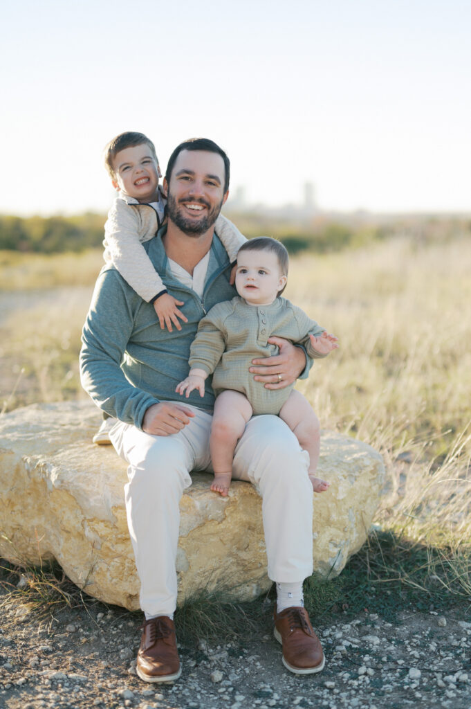 family portrait dad and two boys outdoors