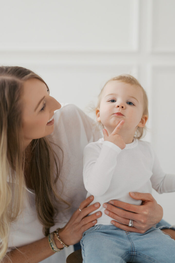 little girl makes silly face with mom in fort worth photo studio