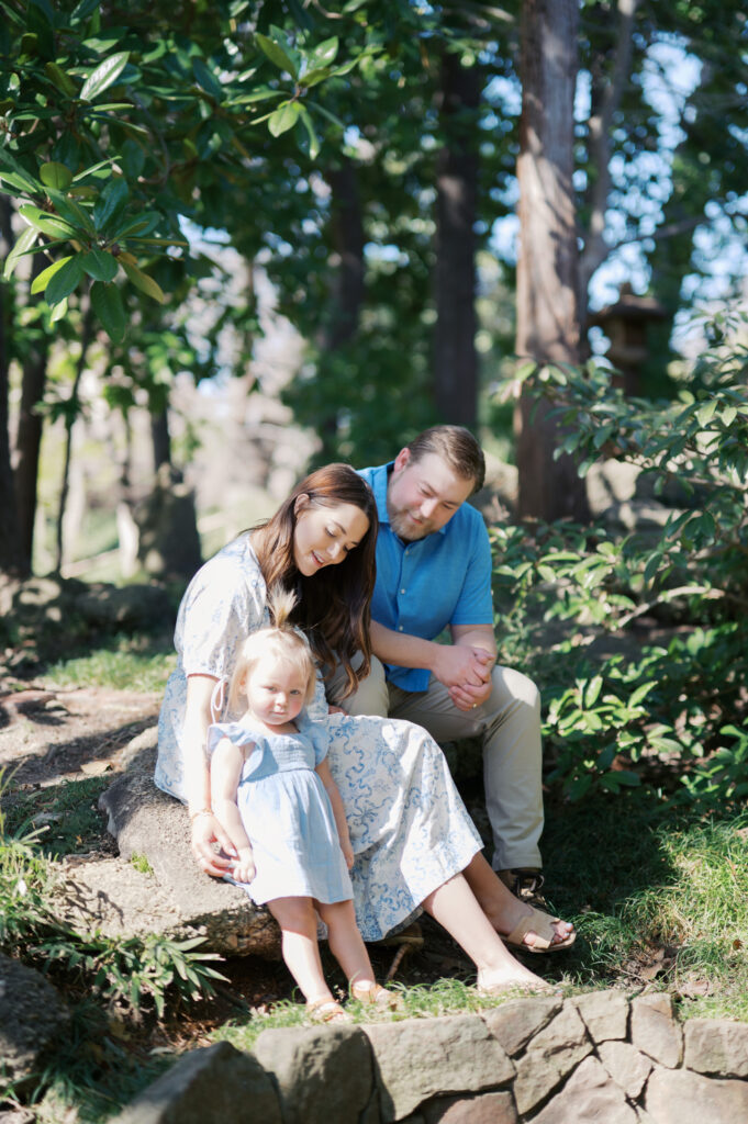 family sits in the Japanese Tea Garden at the Fort Worth Botanic Garden