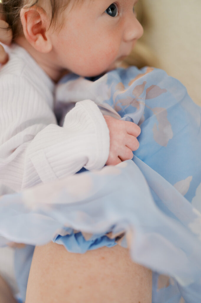 newborn baby snuggles on mom's shoulders