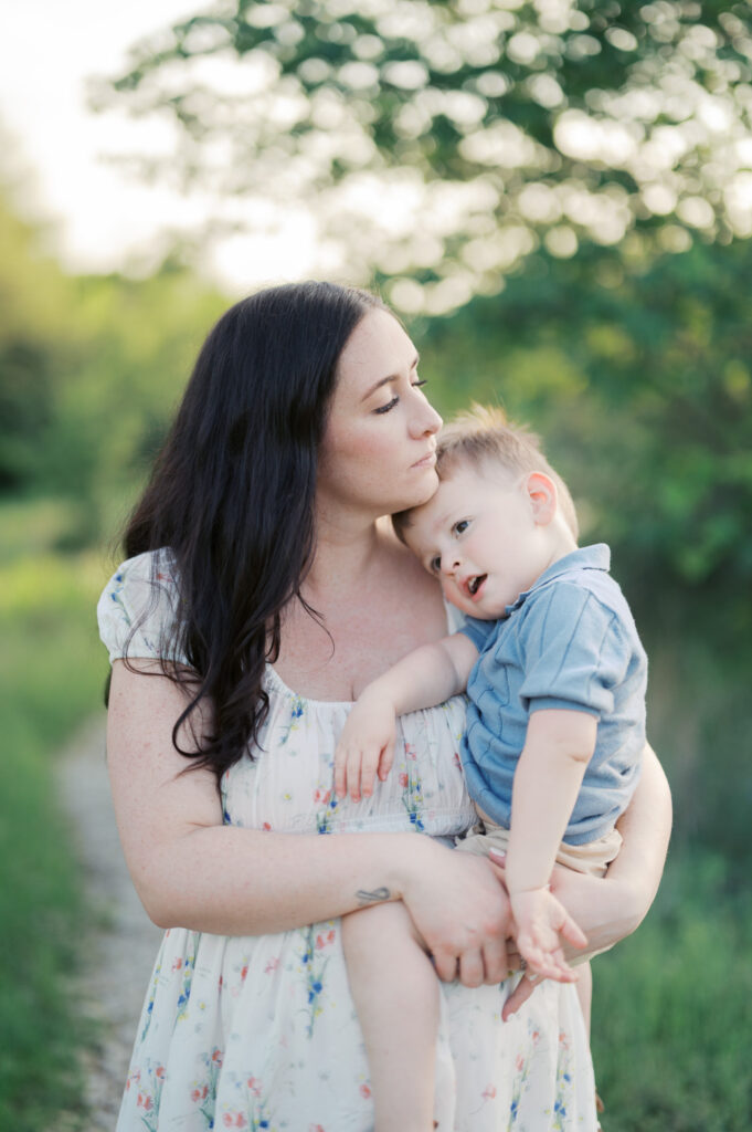 maternity family session in fort worth, mom snuggles baby boy close