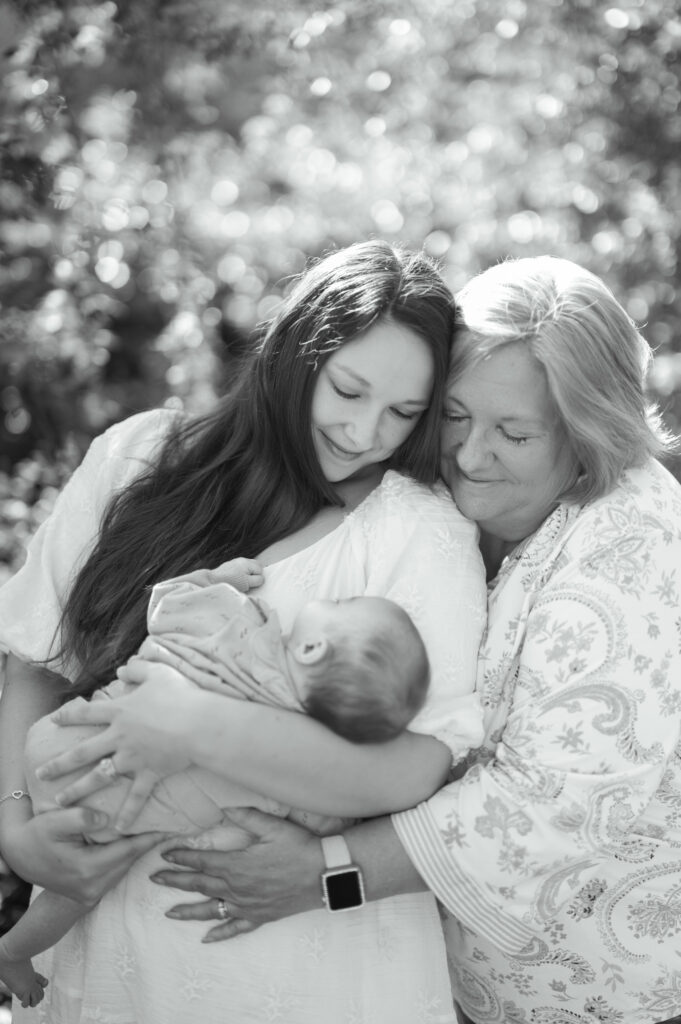 mom and grandma look adoringly at baby girl