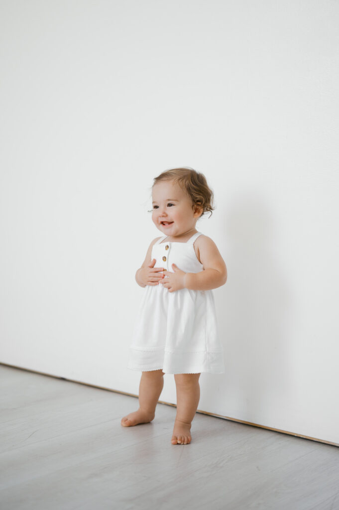 one year old smiles during studio photos in fort worth
