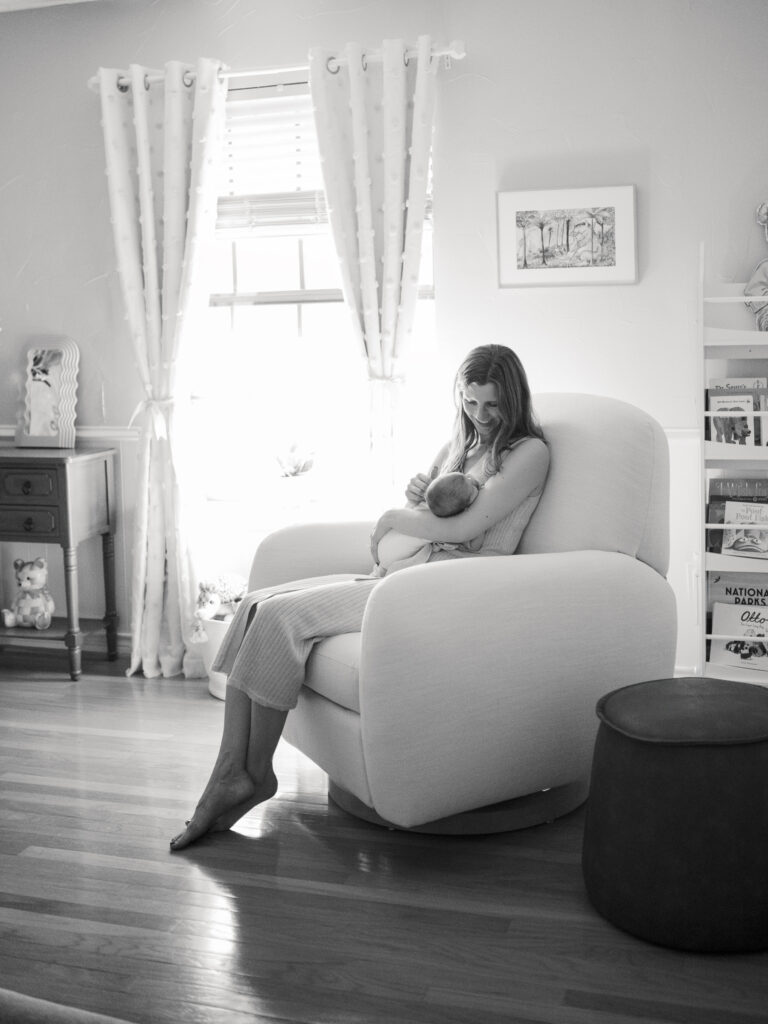 mom rocks newborn baby in nursery during in home lifestyle newborn photos in fort worth